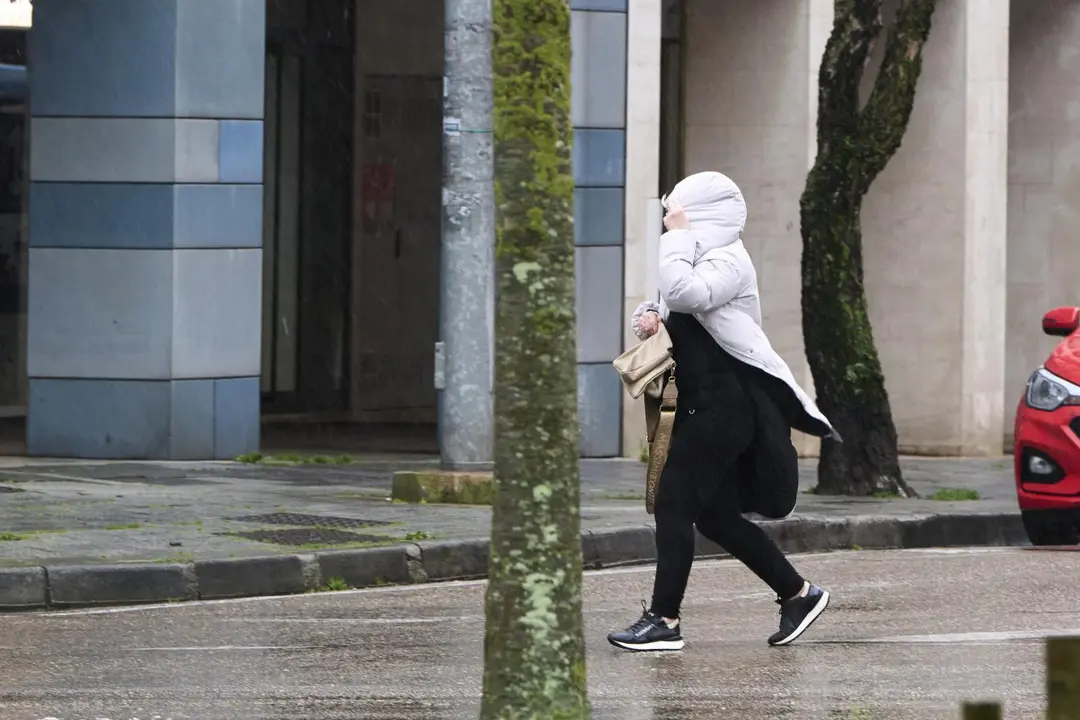 Mujer se protege del fr&iacute;o y el viento. - C&eacute;sar Ortiz / Europa Press